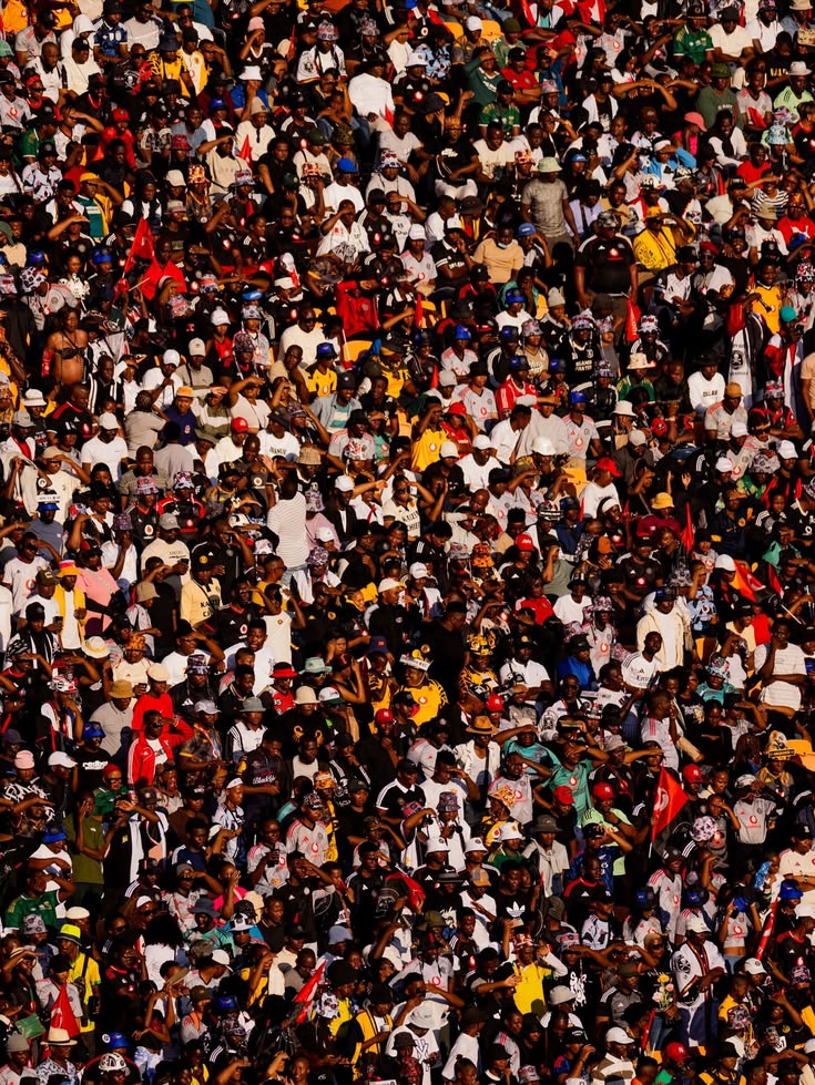 A dense crowd of community members gathered together in the stands